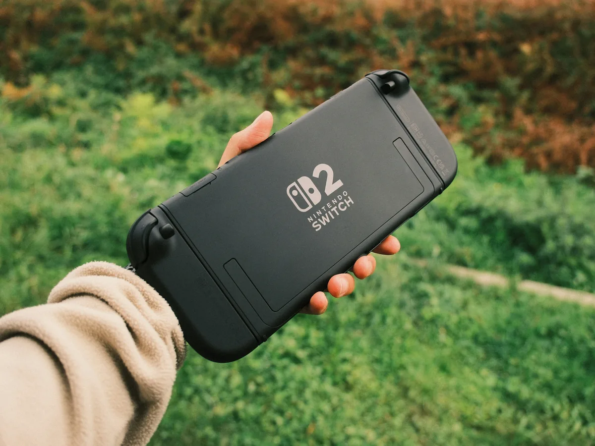 Real Nintendo Switch 2 handheld gaming system held outdoors